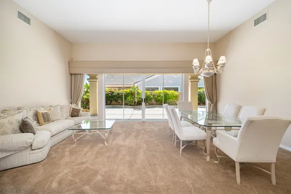a large white kitchen with a large window