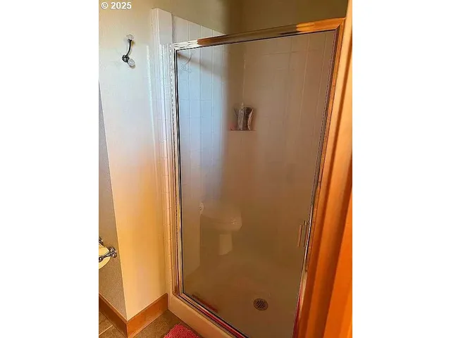 a bathroom with a shower and a door