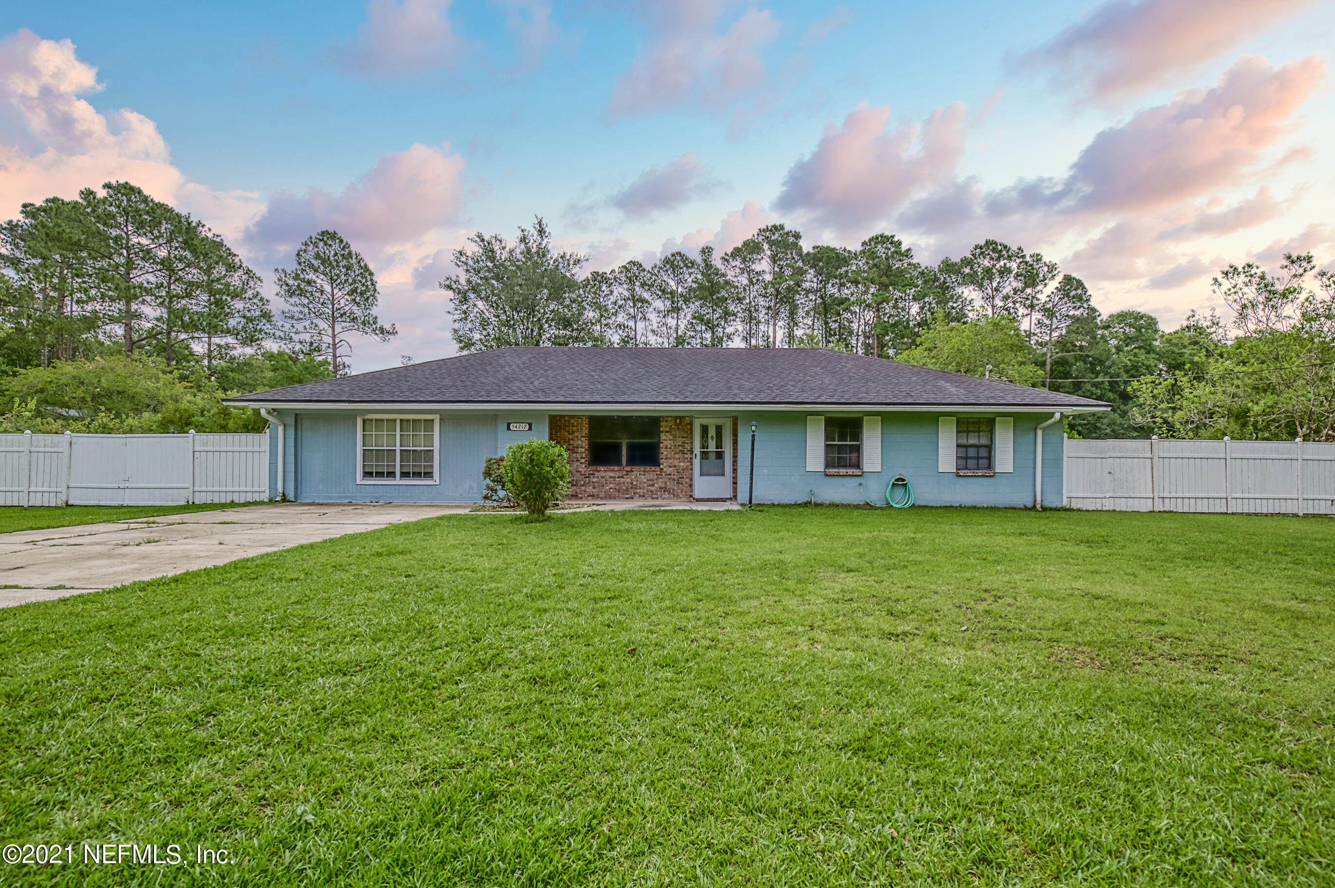54212 Armstrong Road Callahan, FL 32011 - Photo 1 of 47 a front view of a house with a garden