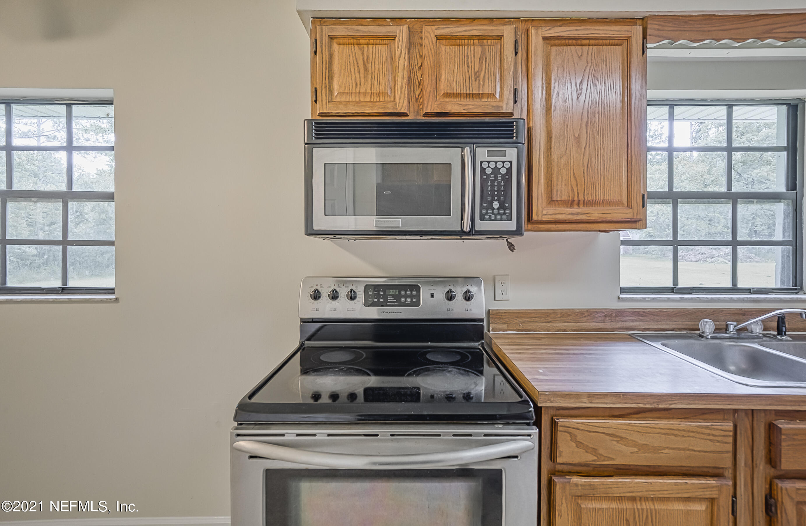54212 Armstrong Road Callahan, FL 32011 - Photo 11 of 47 a stove top oven sitting inside of a kitchen