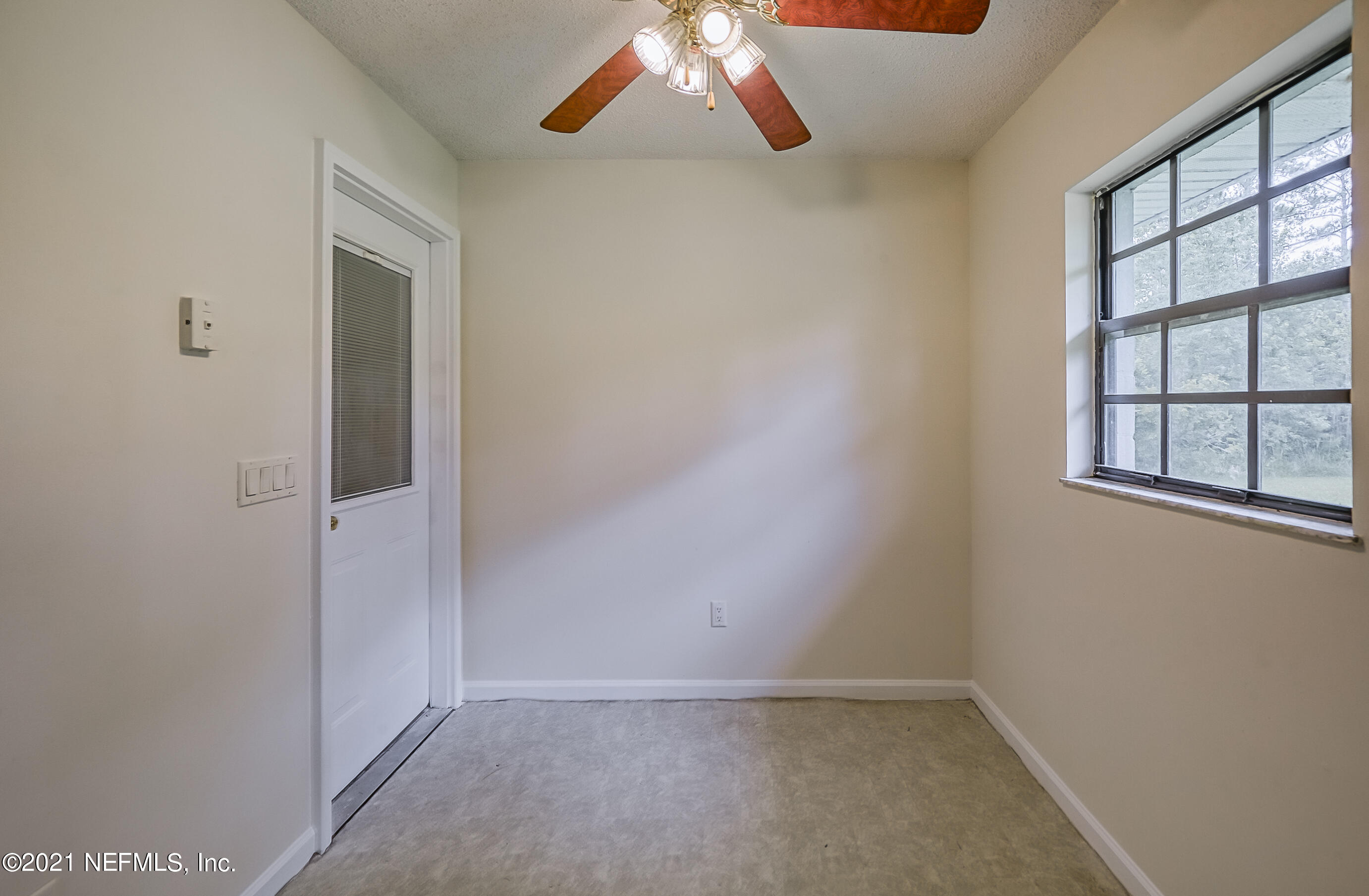 54212 Armstrong Road Callahan, FL 32011 - Photo 12 of 47 an empty room with windows and fan