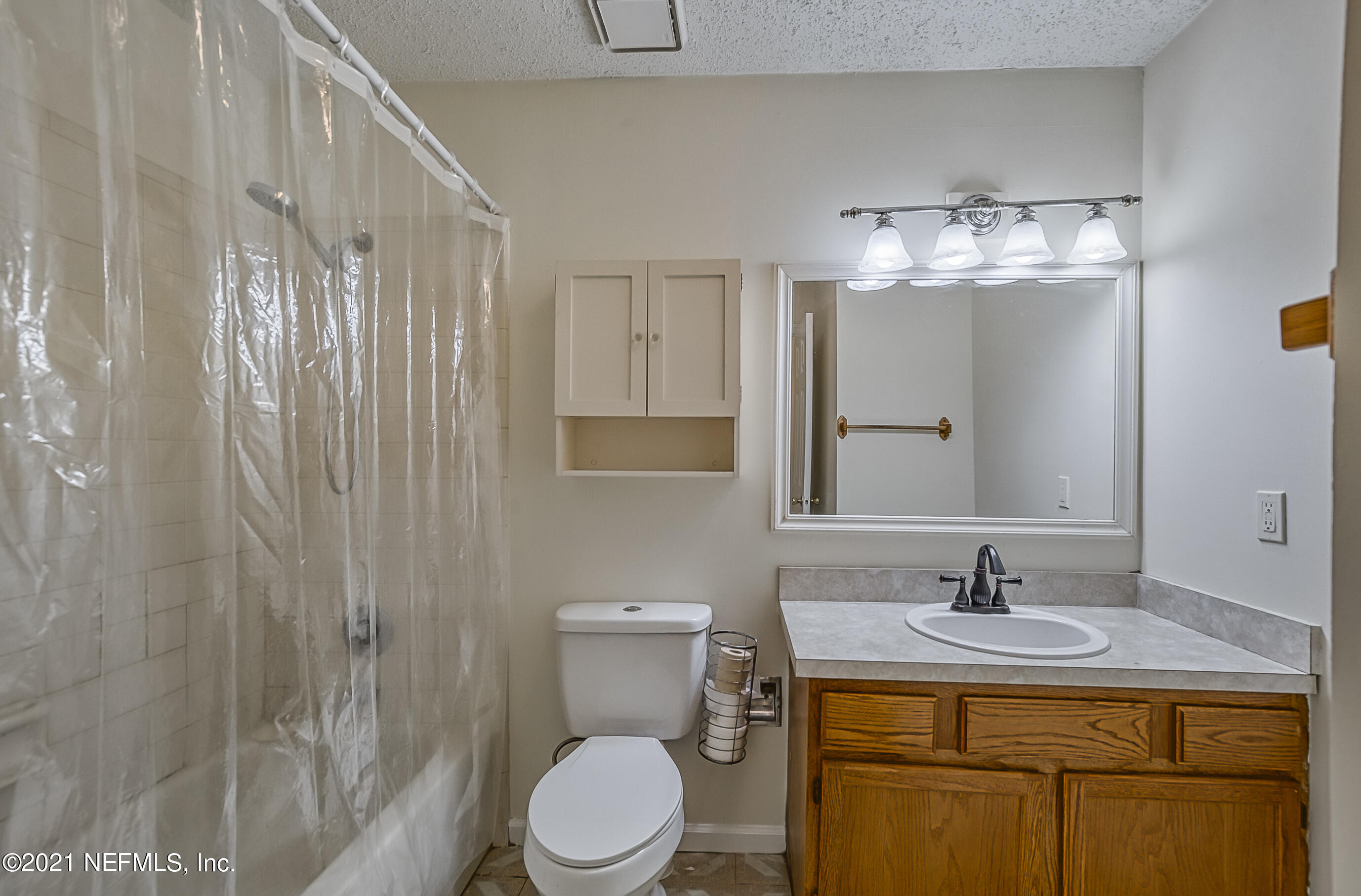 54212 Armstrong Road Callahan, FL 32011 - Photo 17 of 47 a bathroom with a toilet a sink and mirror