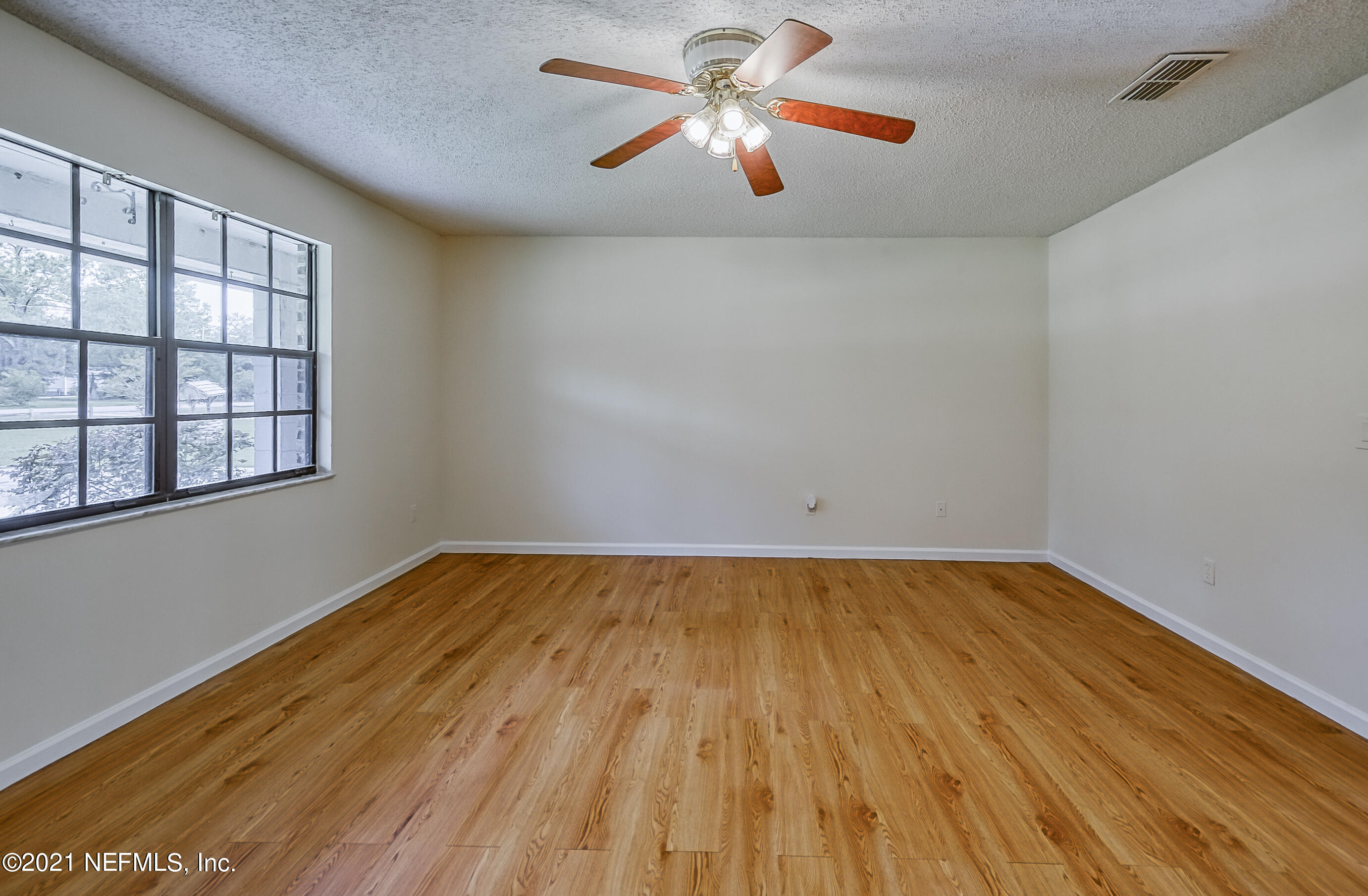 54212 Armstrong Road Callahan, FL 32011 - Photo 19 of 47 a view of empty room with wooden floor and fan