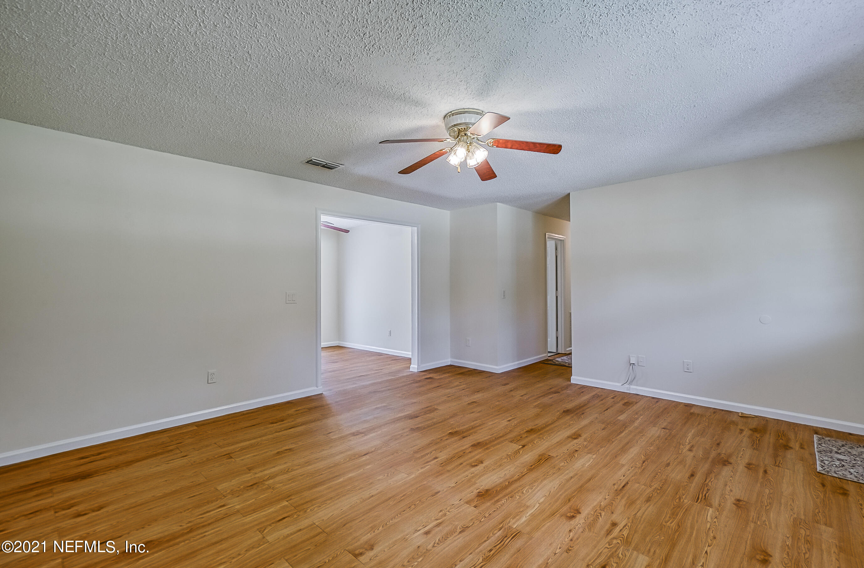54212 Armstrong Road Callahan, FL 32011 - Photo 20 of 47 a view of an empty room with window and wooden floor
