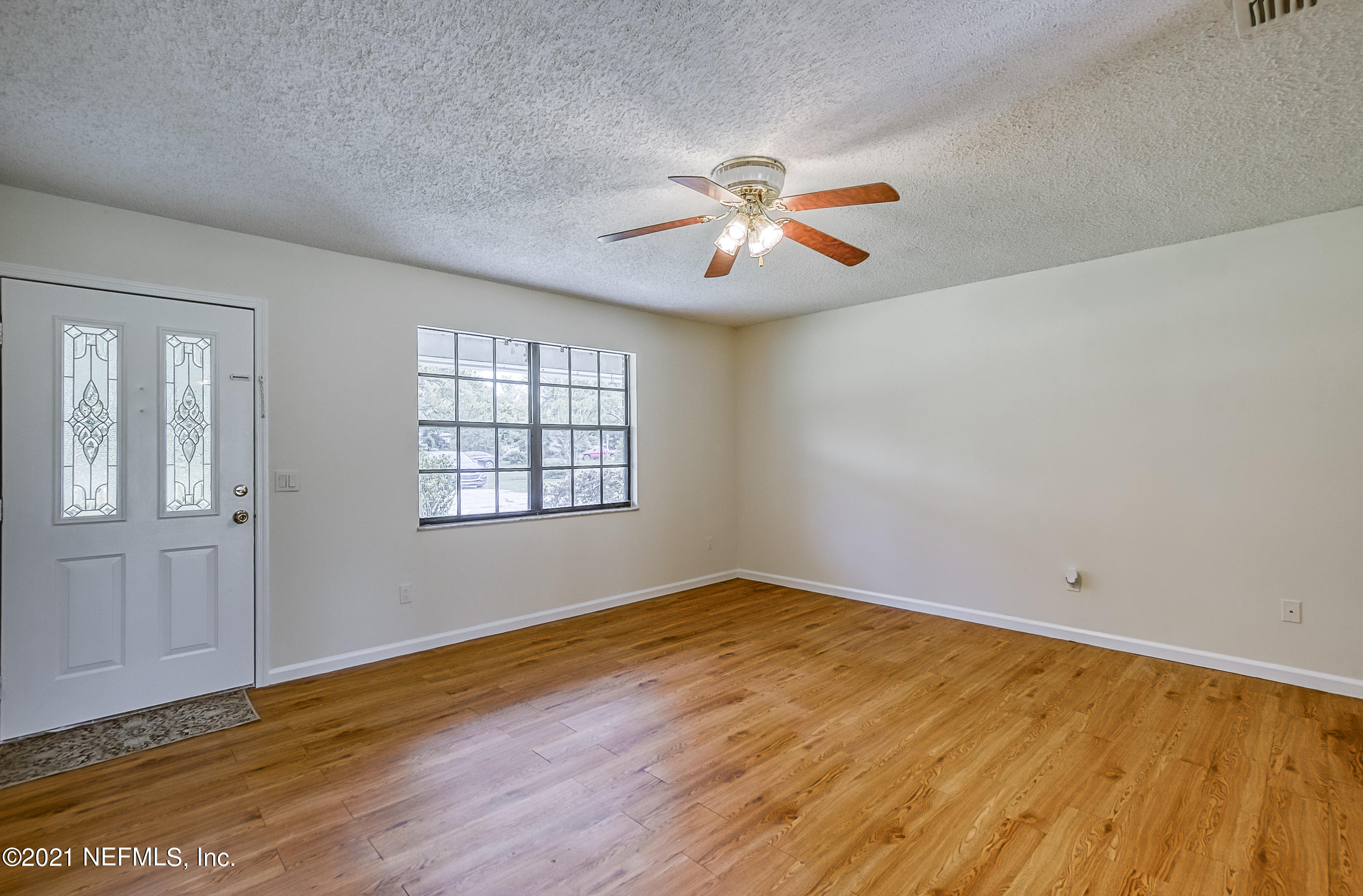 54212 Armstrong Road Callahan, FL 32011 - Photo 23 of 47 a view of empty room with wooden floor and fan