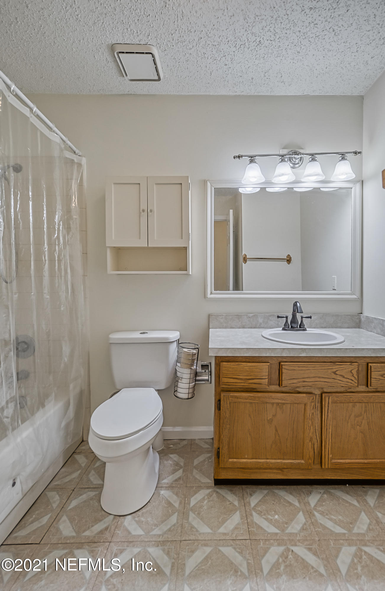 54212 Armstrong Road Callahan, FL 32011 - Photo 24 of 47 a bathroom with a granite countertop sink a toilet a mirror and shower