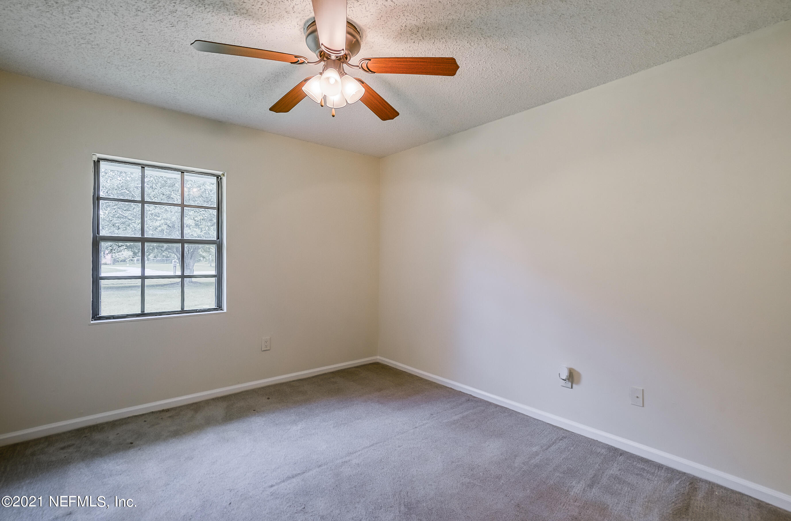 54212 Armstrong Road Callahan, FL 32011 - Photo 25 of 47 an empty room with windows and chandelier fan