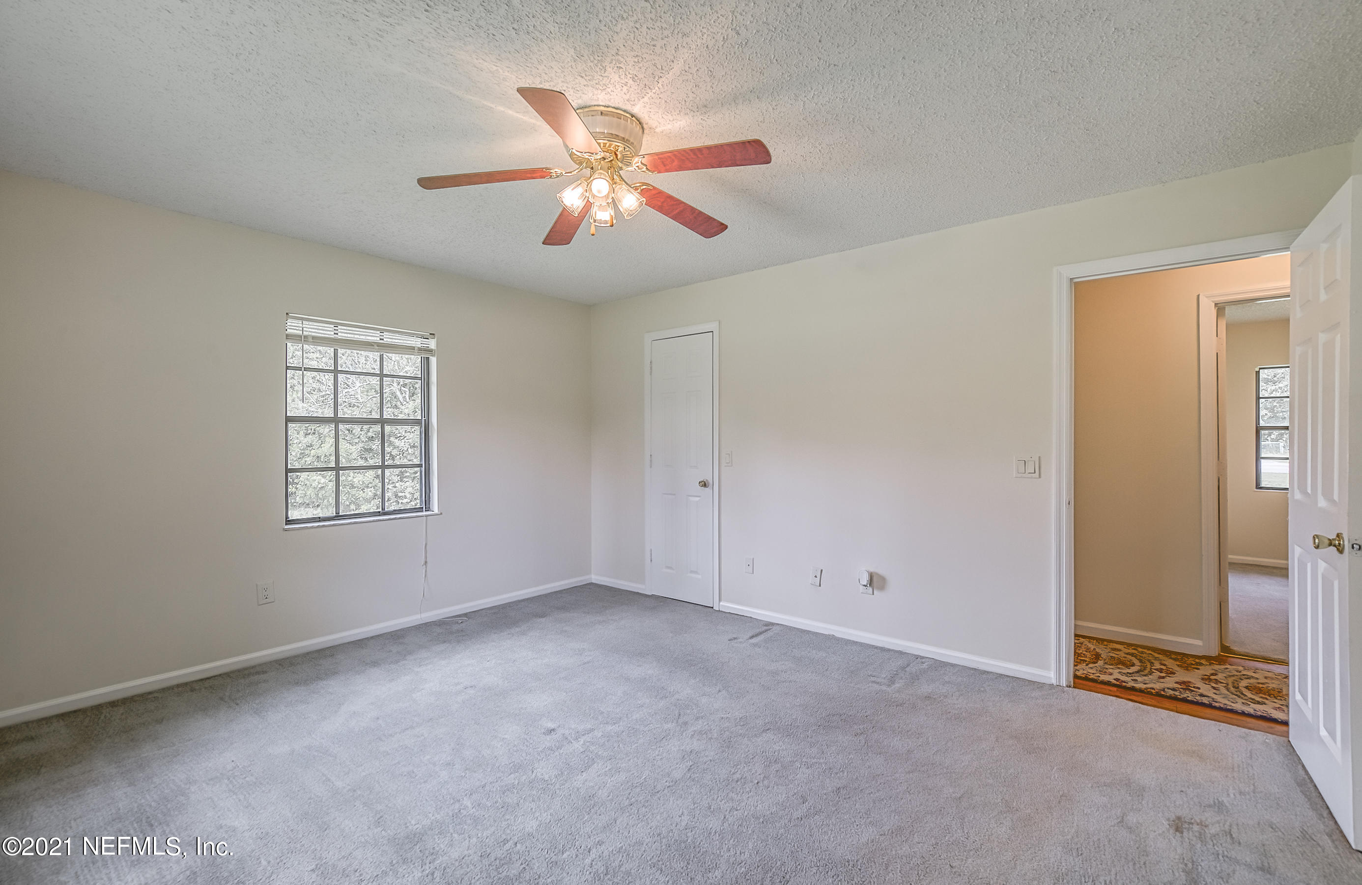 54212 Armstrong Road Callahan, FL 32011 - Photo 26 of 47 an empty room with windows and fan