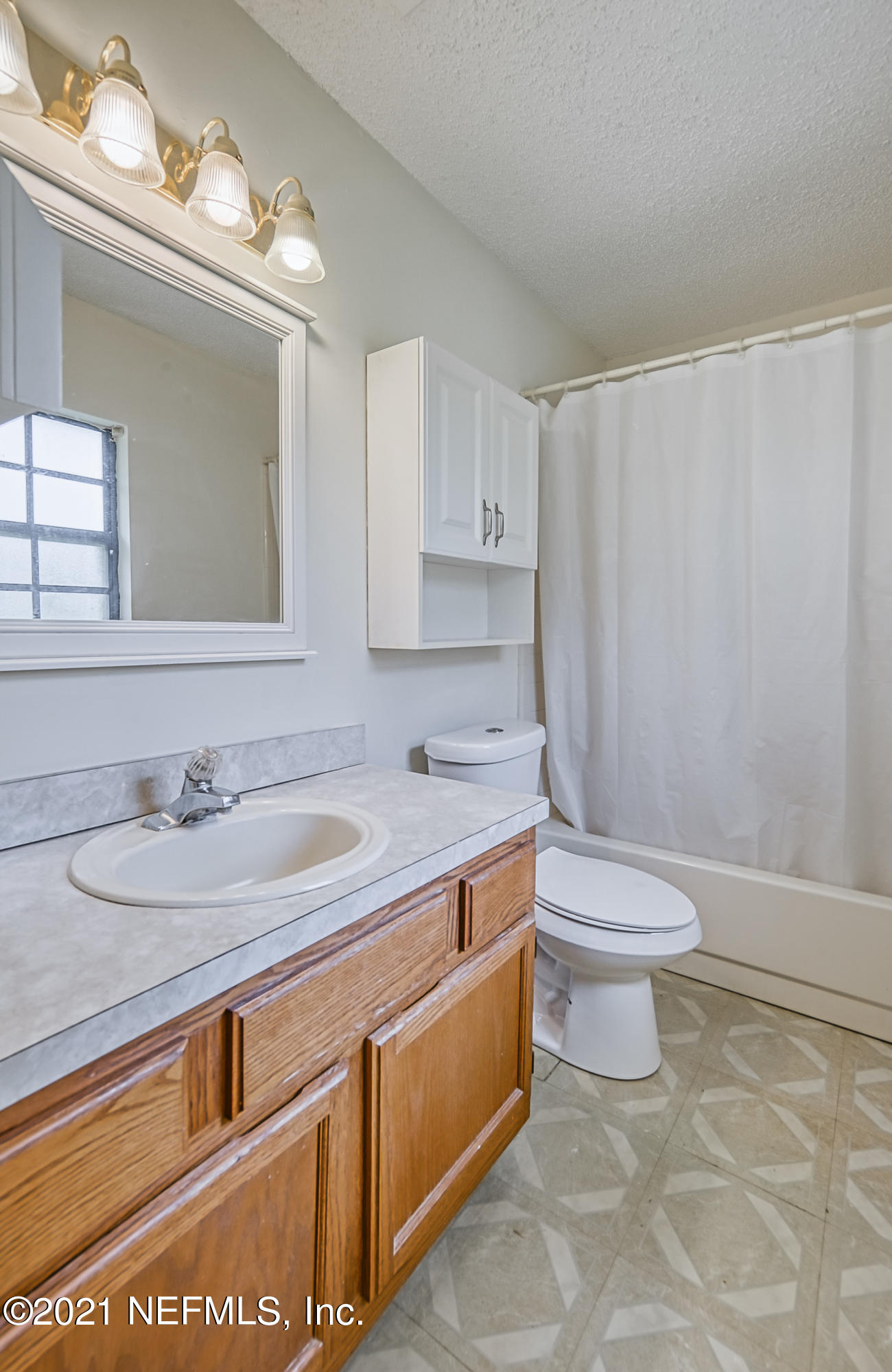 54212 Armstrong Road Callahan, FL 32011 - Photo 28 of 47 a bathroom with a sink a toilet and a mirror