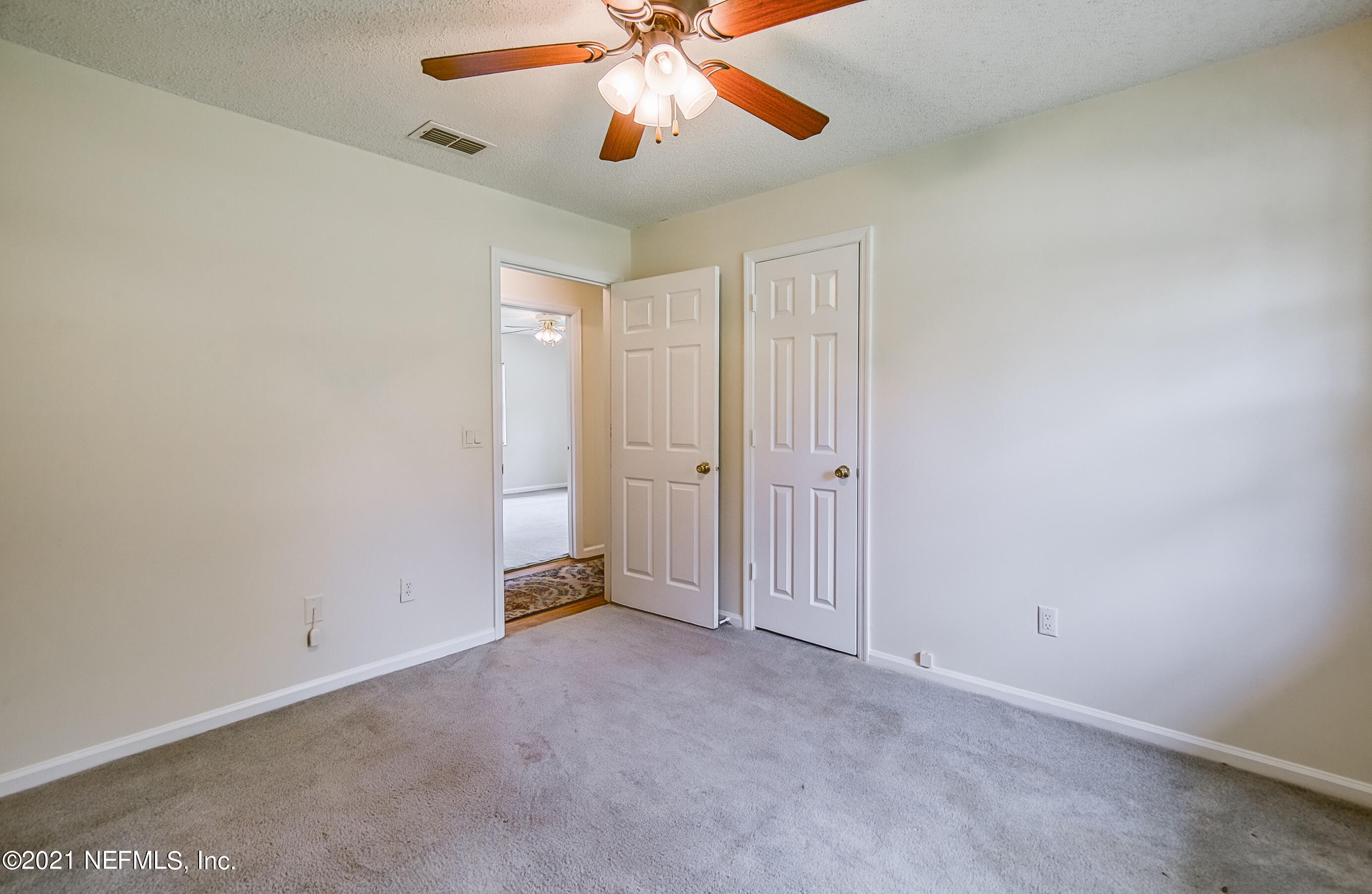 54212 Armstrong Road Callahan, FL 32011 - Photo 32 of 47 an empty room with closet and a chandelier fan