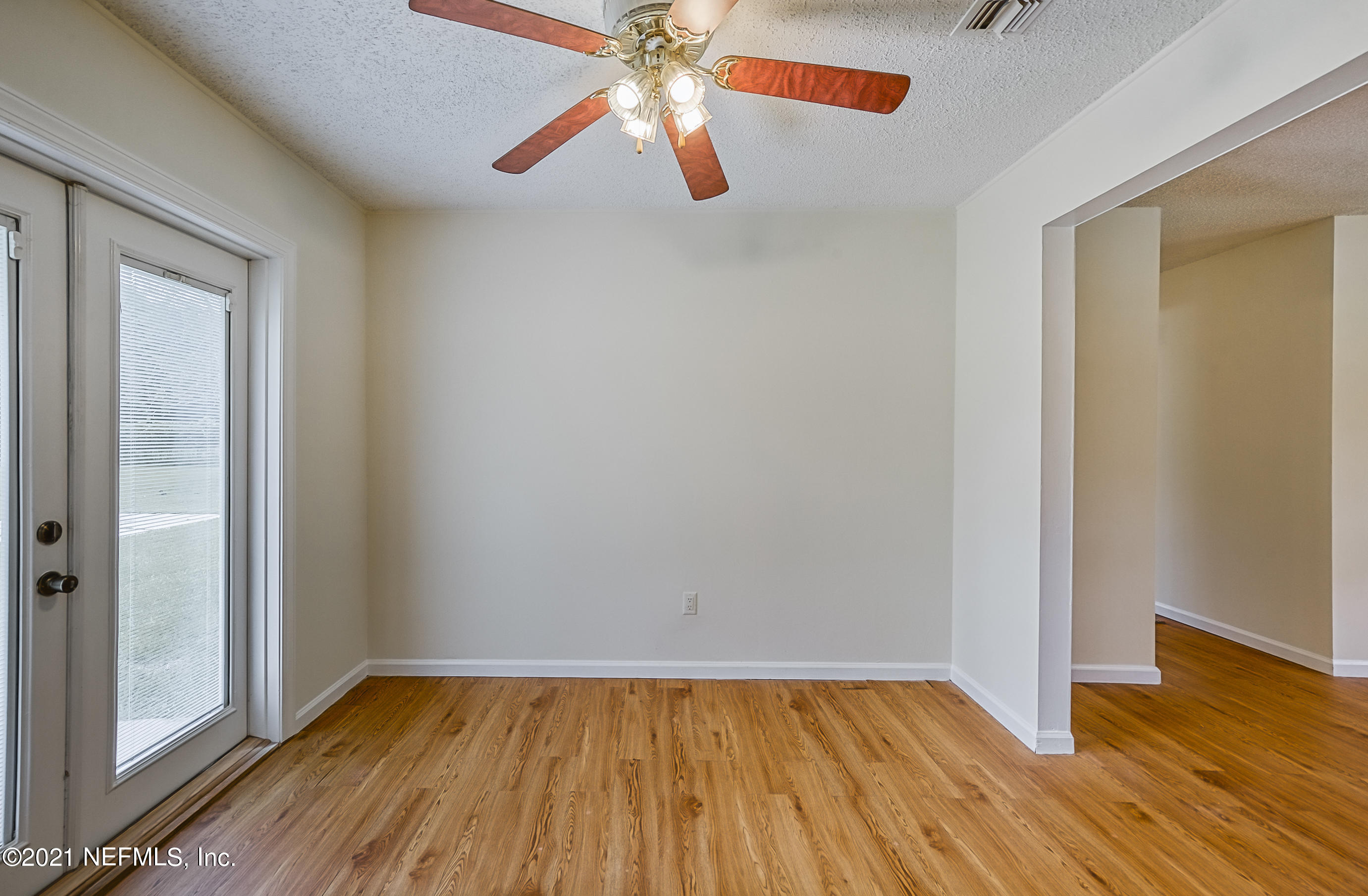 54212 Armstrong Road Callahan, FL 32011 - Photo 33 of 47 a view of an empty room with wooden floor and a window