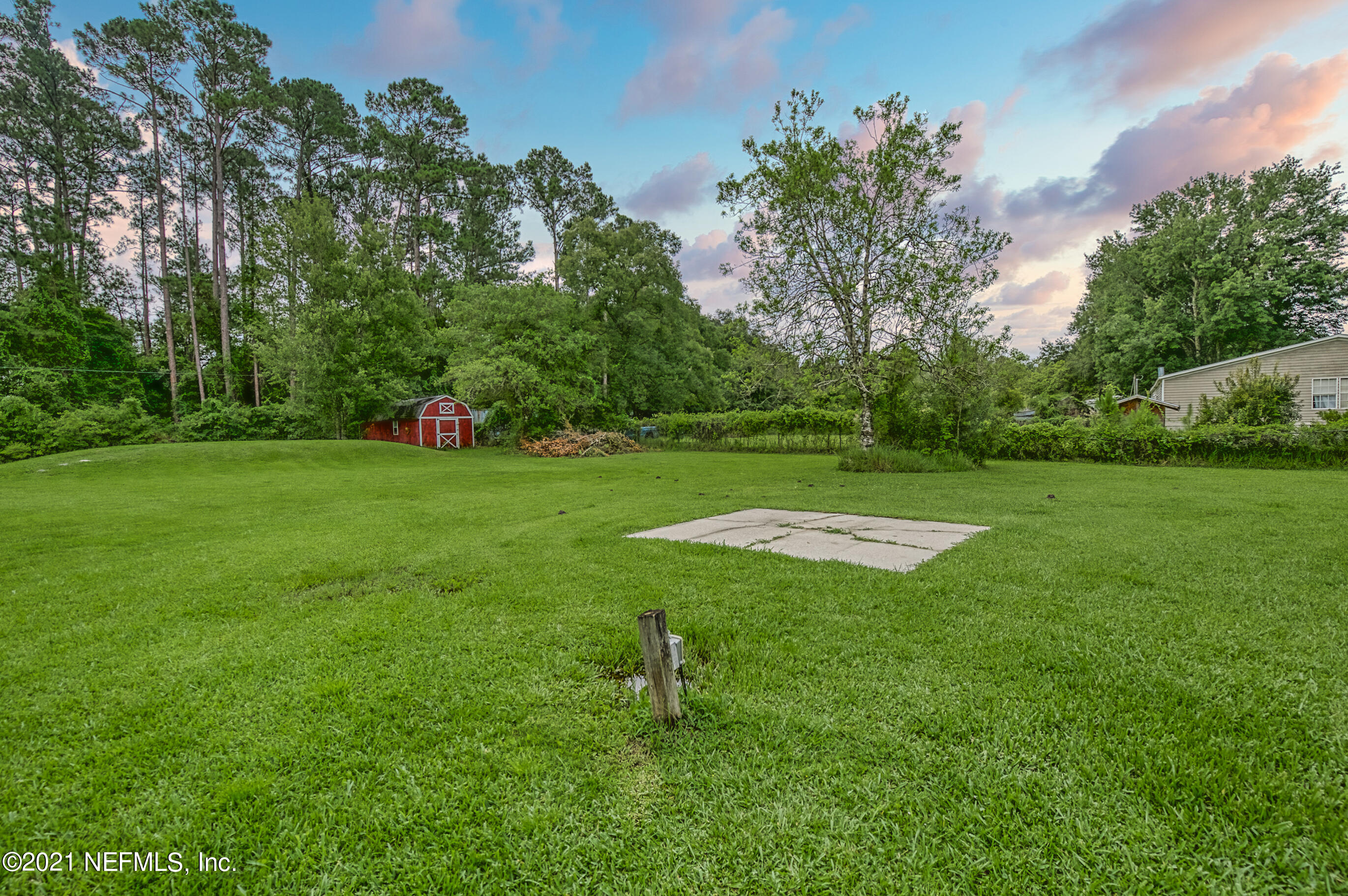 54212 Armstrong Road Callahan, FL 32011 - Photo 40 of 47 a swimming pool with lots of green space and trees in the background