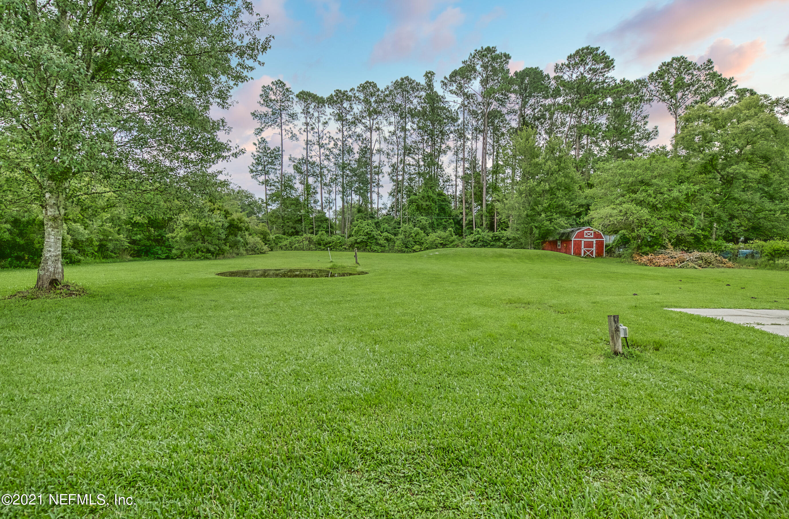 54212 Armstrong Road Callahan, FL 32011 - Photo 5 of 47 a view of a green field with trees in the background
