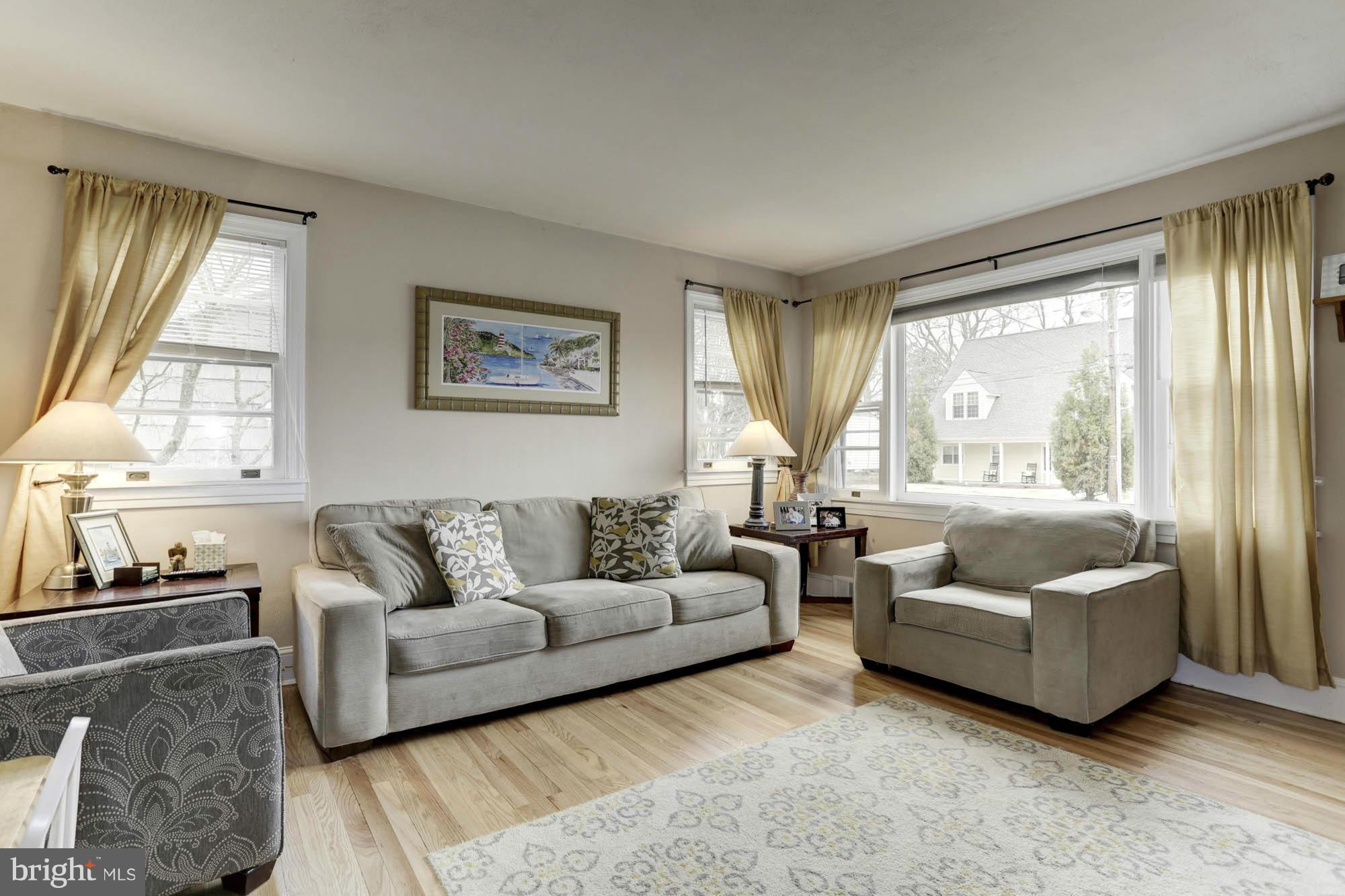 213 Gibson Road Annapolis, MD 21401 - Photo 11 of 30 Light-Filled Living Room Showcasing Wood Floors