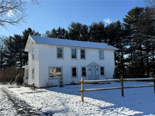a view of a white house with a outdoor space