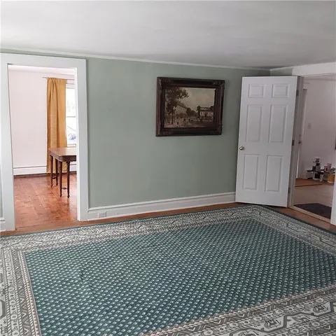 a view of a room with wooden floor