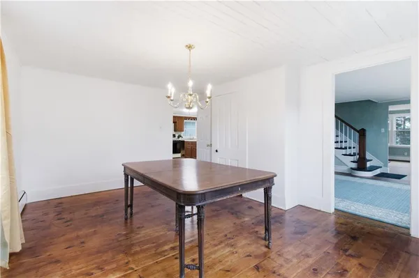 a view of a room with furniture and wooden floor