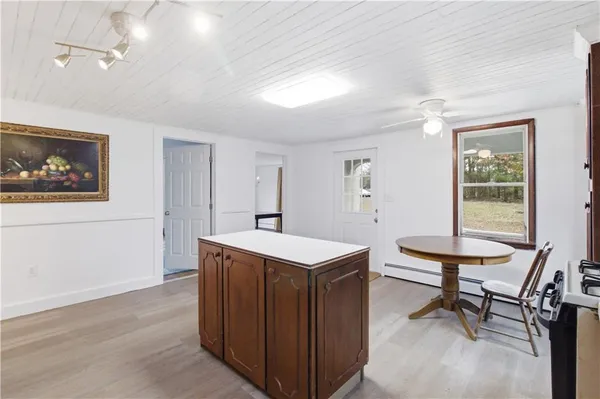 a view of a room that has a table and chairs in it