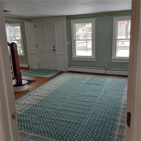 a view of entryway with wooden floor and stairs