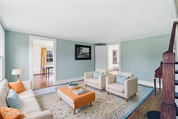a living room with furniture and wooden floor