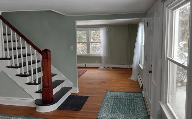 a view of a room with wooden floor