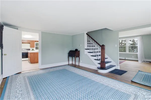 a view of a livingroom with wooden floor and furniture