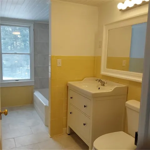 a white toilet sitting next to a bathroom sink