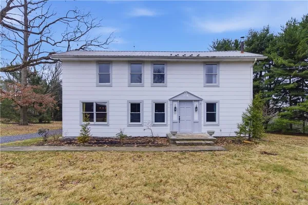 a front view of a house with a yard