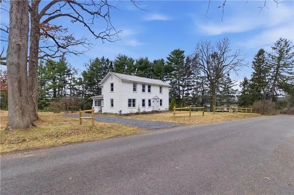 a view of a house with pool and a yard