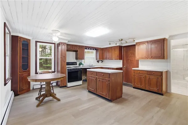 a kitchen with a refrigerator a sink and cabinets