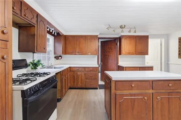 a kitchen with stainless steel appliances granite countertop a sink stove and cabinets
