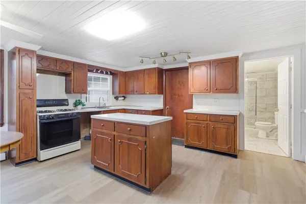 a kitchen with a stove top oven sink and cabinets