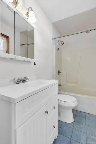 a view of a white house with a table and chairs