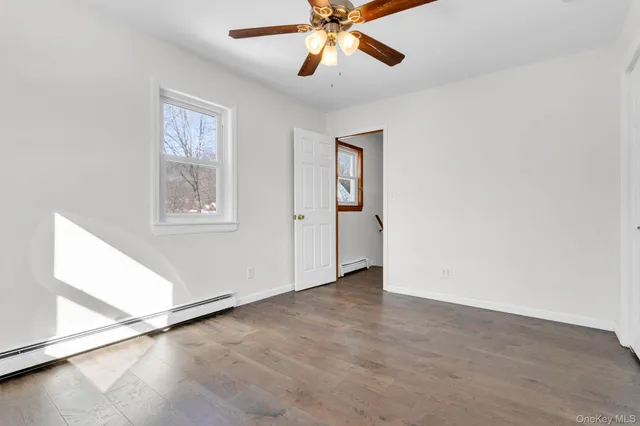 a view of a balcony with furniture and wooden floor