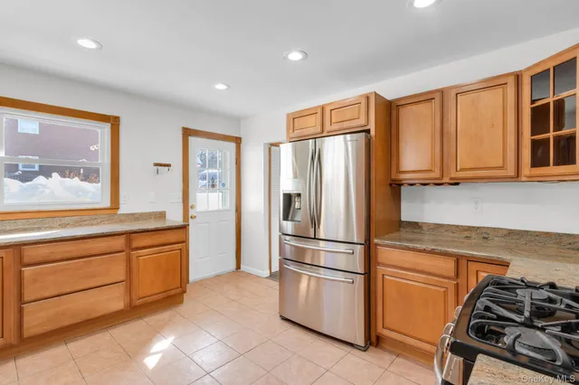 a view of an empty room with window and fireplace