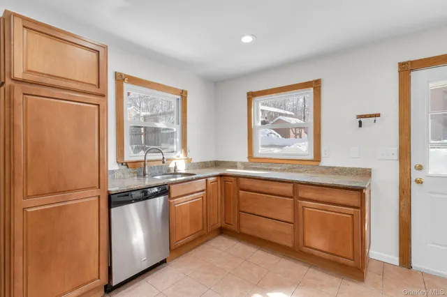 an empty room with wooden floor and chandelier
