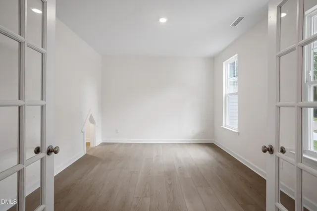 a view of room with window and wooden floor