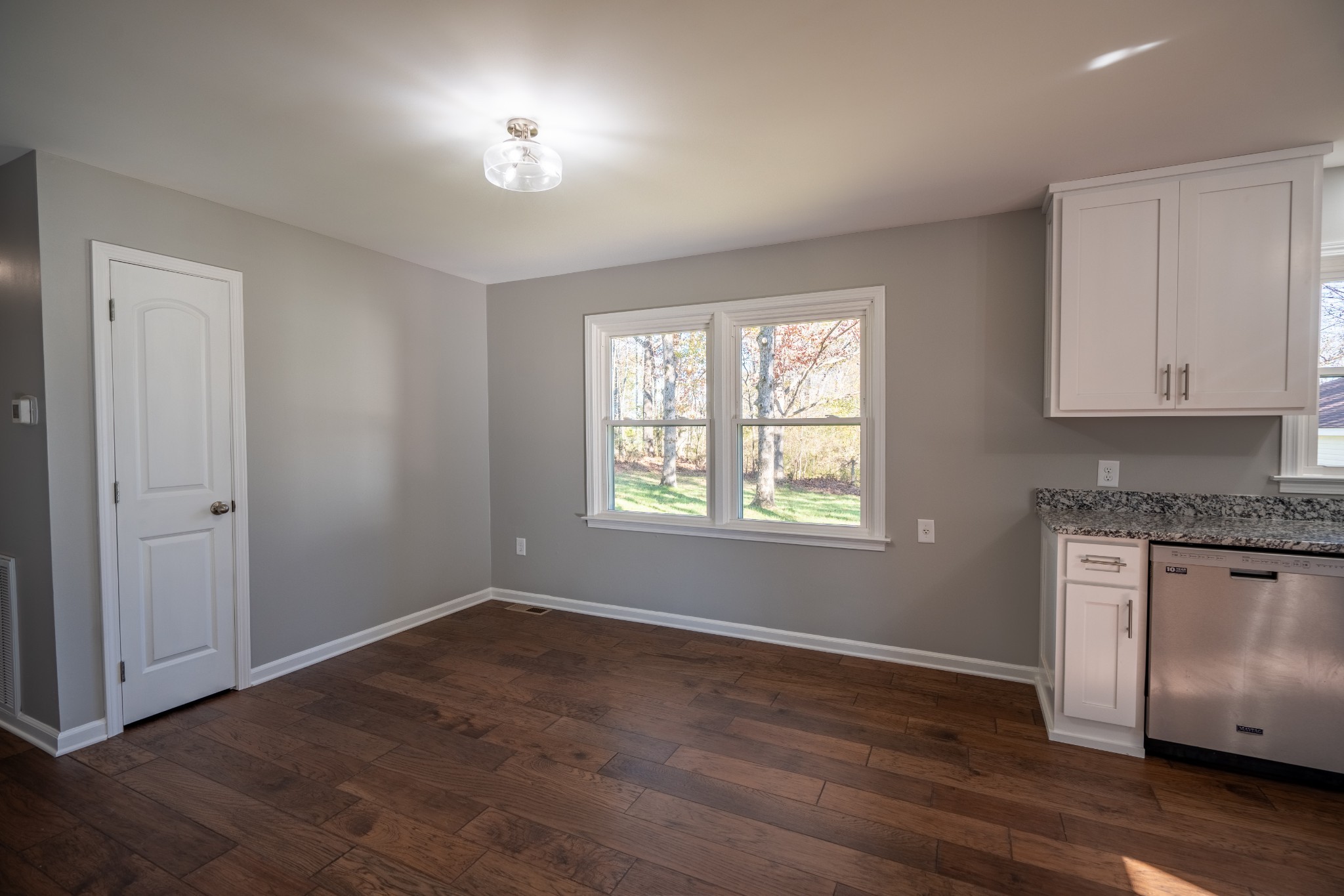 3993 Clanton Road Lawrenceburg, TN 38464 - Photo 11 of 24 an empty room with wooden floor cabinet and windows
