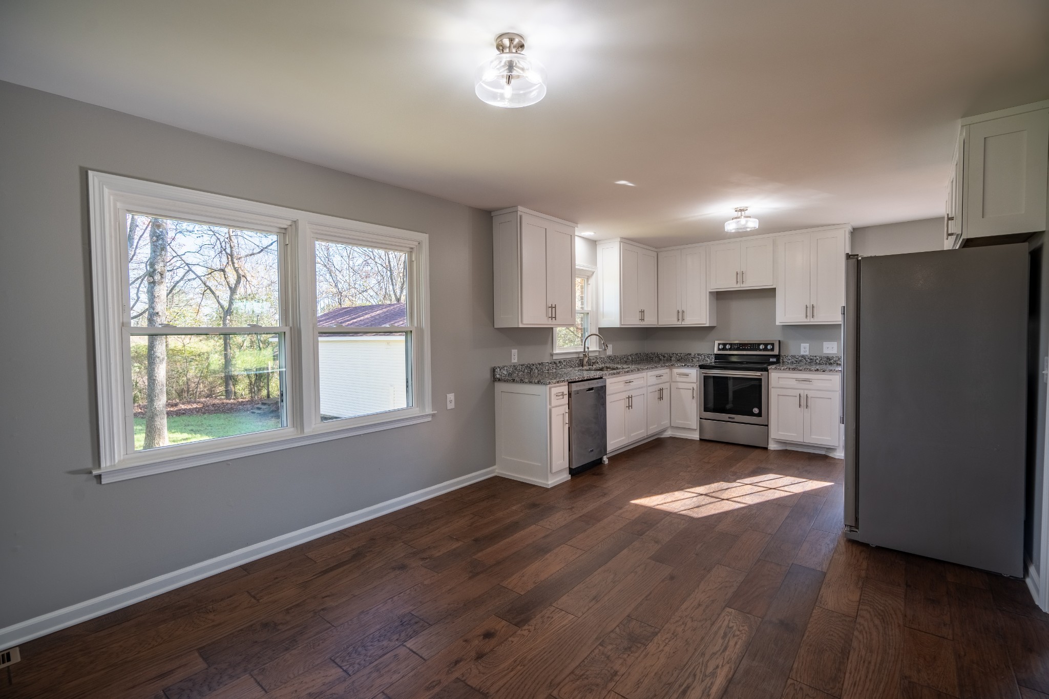 3993 Clanton Road Lawrenceburg, TN 38464 - Photo 13 of 24 a kitchen with granite countertop stainless steel appliances a refrigerator cabinets and a window