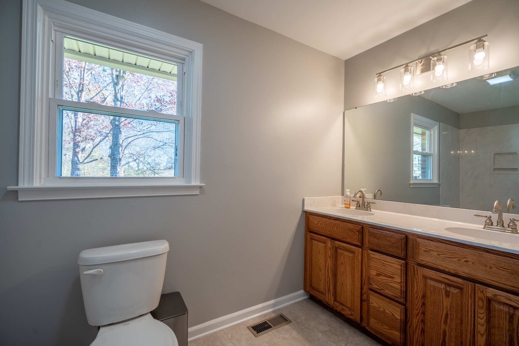 3993 Clanton Road Lawrenceburg, TN 38464 - Photo 19 of 24 a bathroom with a toilet sink and mirror