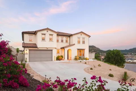 a front view of a house with a yard and a garage