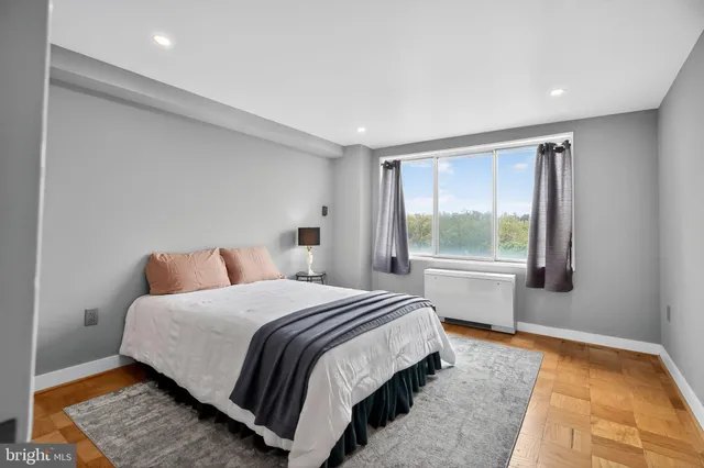 a bedroom with a bed lamp and window