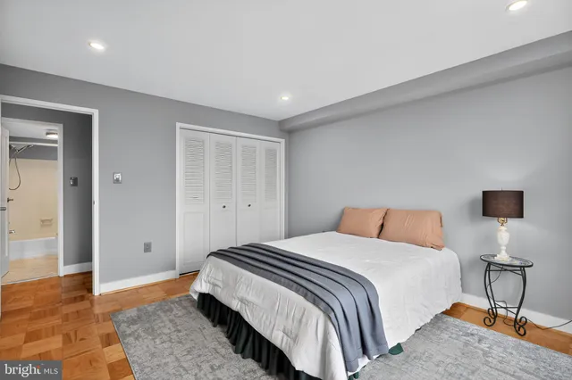 a bedroom with a bed and a lamp