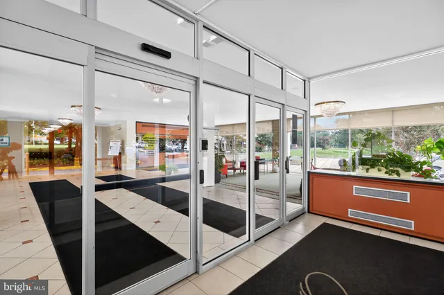 a living room with lots of furniture and a chandelier
