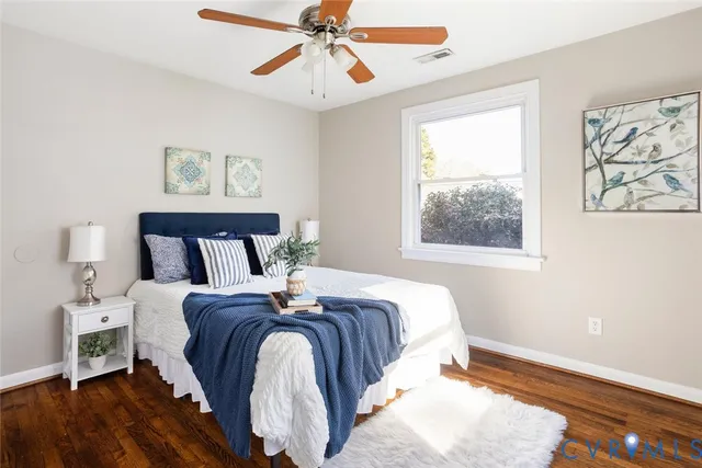 a bedroom with bed and wooden floor