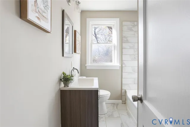 a white toilet sitting next to a bathroom sink