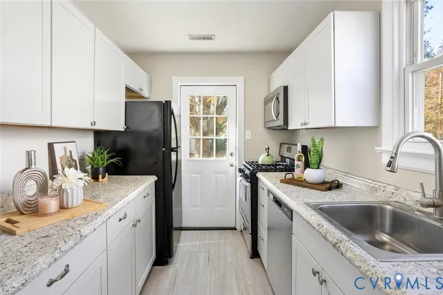 a kitchen with a sink cabinets and a window