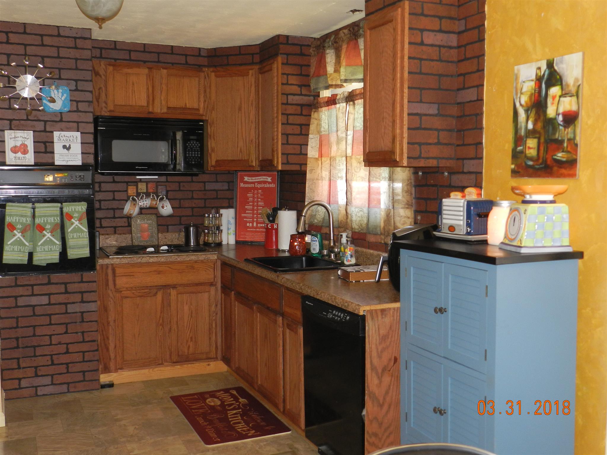 411 Burch Road Clarksville, TN 37042 - Photo 5 of 19 a kitchen with granite countertop a stove a sink and a microwave