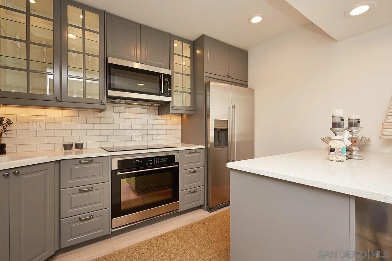 940 Sealane Drive, Unit 5 Encinitas, CA 92024 - Photo 11 of 49 a kitchen with stainless steel appliances a stove microwave and sink