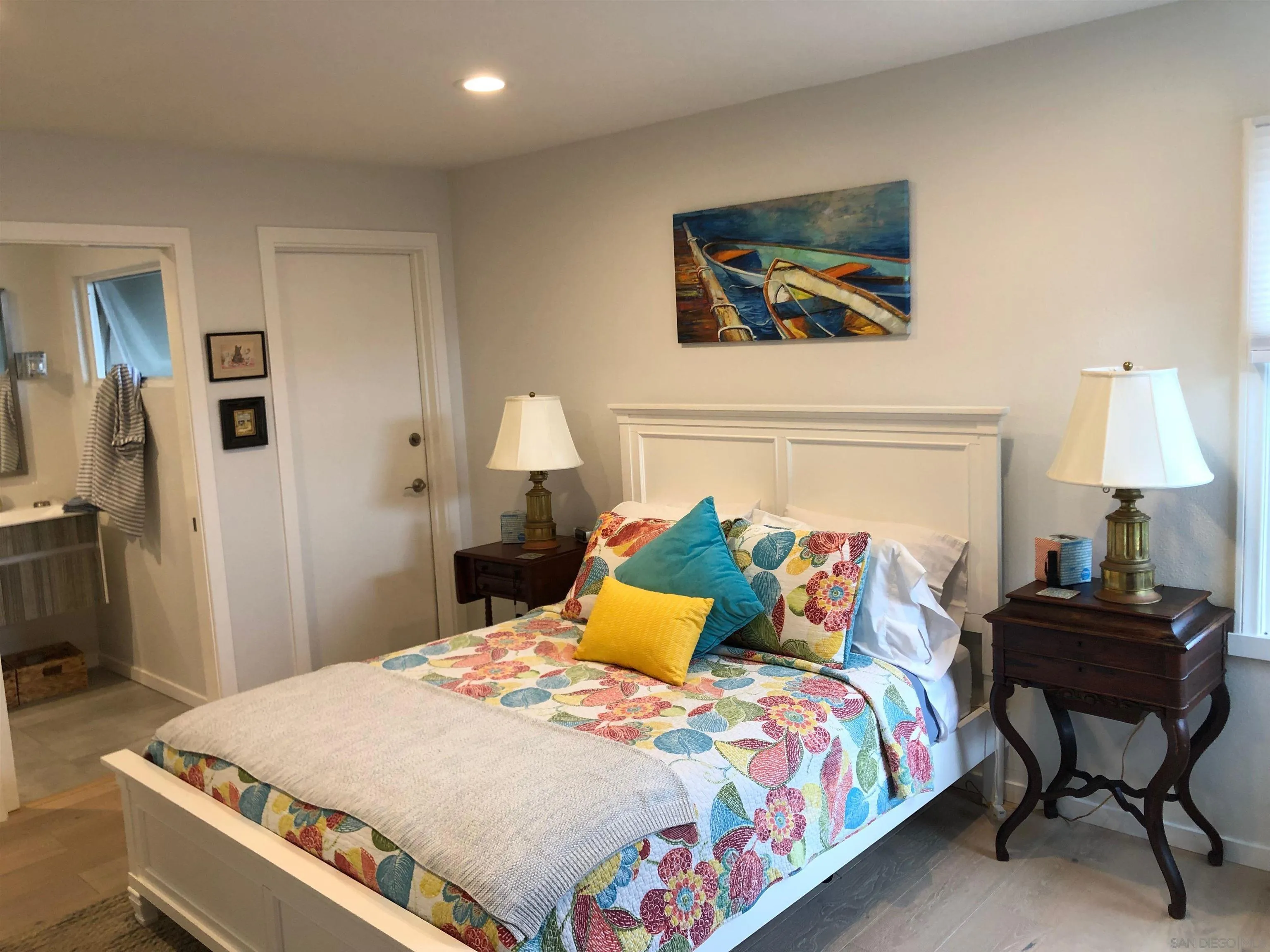 940 Sealane Drive, Unit 5 Encinitas, CA 92024 - Photo 14 of 49 a large bed sitting in a bedroom and a table